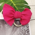 Detailed macro view of large rose red lace mesh bow on a beige nylon baby headband - Rose Red