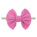 Detail of bright pink waffle weave bow on a soft stretch nylon headband for babies - Pink