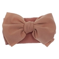 Close-up of soft nylon fabric texture and large bow detail on baby headband - Pink