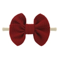 Close-up of dark red nylon bow headband for babies with textured ribbed fabric - Burgundy