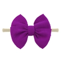 Detail of a purple textured bow headband with high-elastic nylon band for infants - Fuschia