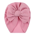Close-up of pink waffle fabric texture and large bow on this baby turban hat - One Size / Light Pink