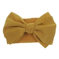 Elastic mustard yellow nylon headband for babies featuring a large textured bow detail - Turmeric