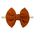 Diadema elástica de nailon para bebé con lazo de tela gofrada en color naranja quemado - Rojo Óxido