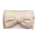 Detailed macro view of the soft beige bow and elastic texture on the infant headband - Off-white