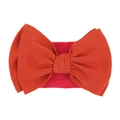 Elastic baby nylon headband featuring a large orange waffle texture bow for infants - Rust red