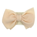 Soft waffle knit baby headband with a large double bow in light peach pink color - Off-white
