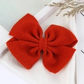 Handmade bright orange waffle knit hair bow accessory for children with textured fabric - Rust red