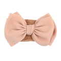 Pink waffle knit nylon headband for baby girls with a large soft bow decoration - Blush