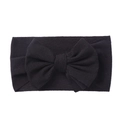 Detail of black elastic knitted baby headband featuring a large 3D ribbed fabric bow - Black