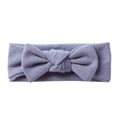 Detail of soft lavender knitted elastic baby headband with a large bow on white background - Light Blue