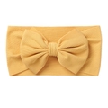 Close-up of ginger yellow knit baby headband showing textured vertical ribbing fabric - Turmeric