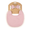 Close-up of pink baby boho bib with white pom-pom trim and matching bow headband - Korean Pink