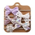 Close-up of 5-piece baby headband set with lace bows and pearls on display card - Style 10