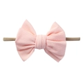 Detailed macro view of soft ribbed cotton bow with a flexible nylon headband for infants - Light Pink
