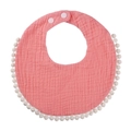 Detail of pink cotton baby bib with decorative white pompom fringe and snaps - Watermelon red