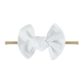 Detailed view of white waffle weave fabric bow and soft nylon baby headband strap - White