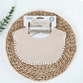 Detail of baby muslin bib and headband set with fringe trim and bows on a display card - Khaki