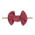Close-up of berry pink waffle fabric bow on a soft stretch nylon baby headband - Dark Korean Pink