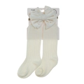 Close-up of ivory baby headband with velvet bow and ribbed cotton socks set - Small (0-12m) / White