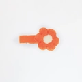 Detail of hand-knitted bright orange flower hair clip with cream center and fabric-wrapped pin - Bright Orange (PP182-29)