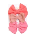 Three pink seersucker bow clips with textured fabric on a white presentation card - Coral Lotus Bright Pink (DP078-4)