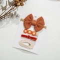 Detail view of 4-piece autumn kids hair accessory set with knitted bow and floral clips - Orange Red Style(DP104-8)
