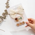 Close-up of three handmade knit hair accessories with cherry embroidery and lace bow - Off-white Style (DP105-1)
