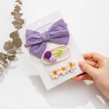 Close-up of handmade knit flower hair clips featuring a purple bow and daisy patterns - Purple Polka Dot Style (DP105-6)