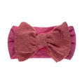 Détail du bandeau bébé rose avec un grand nœud en tissu jacquard à pois - Rose