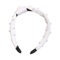 Dettaglio di cerchietto in velluto bianco con eleganti decorazioni di perle e nodo - Bianco