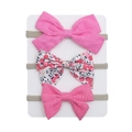 Close-up of three different bow headbands including floral and pink fabric styles - Hot Pink And Red Blue Floral Style (DP114-5)