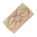 Elastic baby headband with a large waffle texture bow in soft nude beige color - Khaki