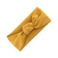 Elastic mustard yellow knit baby headband with a stylish central twist knot design - Ginger Yellow (KK193-43)