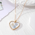 Golden heart-shaped necklace with blue real dried flowers in transparent resin - Blue Flower Necklace