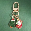 Detail of Christmas snowman and tree charms on a golden alloy metal keychain - Christmas Tree and Sleigh