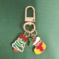 Detailed close-up of a Christmas tree and stocking keychain with golden enamel finish - Bow Christmas Tree and Christmas Sock