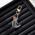 Creative resin cat keychain with real red and green dried flowers inside a gold metal clasp - Red-Green Decorative Flower