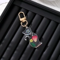 Detailed close-up of resin cat keychain with embedded dried flowers and gold metal clasp - Rose Petals