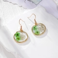 Handmade gold earrings with real green and white dried flowers in round resin charms - Green Flower