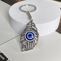 Vintage Silber Schlüsselanhänger mit hohlem Feder-Design und blauer Böser Blick Verzierung - Hohle Feder