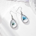 Handmade teardrop earrings with blue dried flowers in transparent resin and silver frames - Blue Tiger Tail Grass