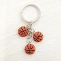 Detail of creative basketball keychain with three realistic resin mini balls and metal ring - Compact Basketball