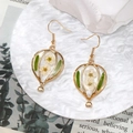 Detailed shot of hot air balloon earrings with real white dried flowers and green leaves - Green Leaf White Flower Balloon