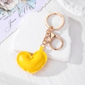 Detail of a bright yellow PU leather heart keychain with golden lobster clasp and ring - Yellow Heart