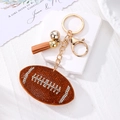 Porte-clés de football américain avec strass brillants et pompon en daim marron - Ballon de football brun (fermoir doré)