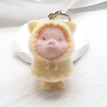 Close-up of cute plush pig keychain with yellow hoodie and soft pink furry texture - Flocking Yellow Raincoat Pig