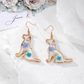 Detailed close-up of dog-shaped gold earrings with blue dried flowers in resin - Blue Flower Dog