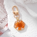 Detailed close-up of hexagonal resin keychain featuring a real orange daisy flower inside - Orange Daisy Hexagon