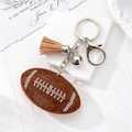 Porte-clés de football américain étincelant avec strass marron et gland en daim - Ballon de football brun (fermoir argenté)